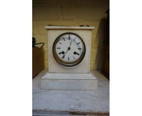 A white marble mantel clock, 20cm high, with pendulum. 