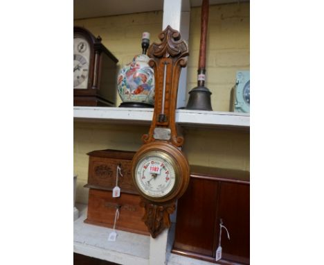A late Victorian carved oak aneroid banjo barometer, with presentation plaque.&nbsp; 