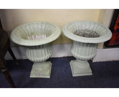 A pair of Constance Spry pale green painted aluminium pedestal urns,&nbsp;labelled, 47cm high.&nbsp; Provenance: from the col