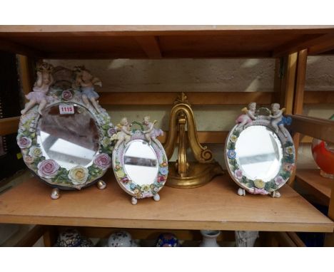 Three Dresden porcelain mirrors,&nbsp;largest 28.5cm high; together with a small giltwood wall bracket.&nbsp; 