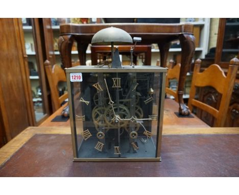 An antique French comtoise type brass and glass clock, with 10 1/2in square dial, with a pair of weights and elaborate brass 