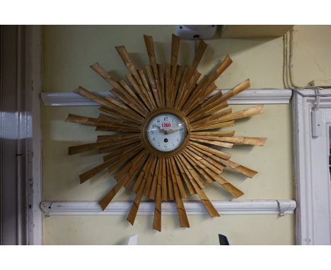 A gilt sunburst wall clock, with white enamel dial, 63cm diameter.&nbsp; 
