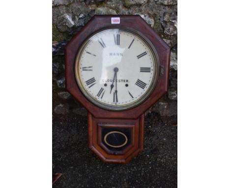 A 19th century American rosewood drop dial wall clock, the 11.5in painted dial inscribed 'Mann, Gloucester', with pendulum. 