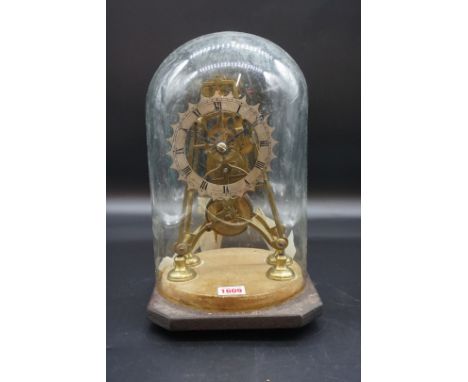 An antique brass fusee skeleton clock,&nbsp;24.5cm high, with pendulum, and glass dome, (dome cracked). 