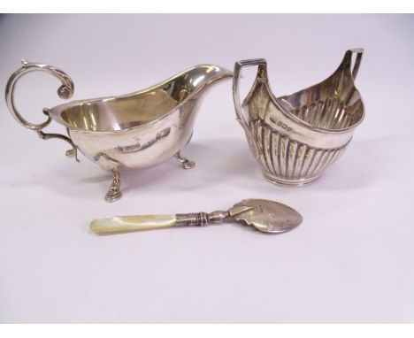 HALLMARKED SILVER, THREE ITEMS to include a three footed sauce boat with scroll handle, Sheffield 1930, indistinct makers mar