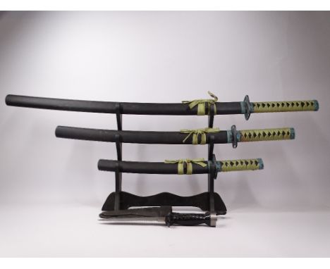 SET OF JAPANESE DISPLAY SWORDS ON STAND and a US Aqualung diver's knife with holster