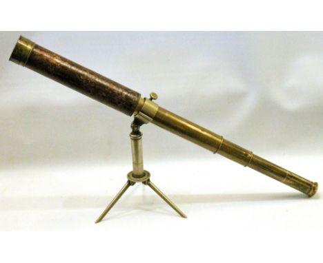 Brass and leather-cased three-draw telescope by Dollond, London, with non-matching folding tripod stand, 24cm high.