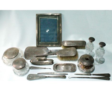 Silver-mounted dressing table set, engine-lined and engraved, Birmingham 1927/8, comprising two brushes and a mirror, a pair 