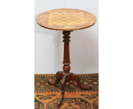 Edwardian mahogany and inlaid tripod games table on a fluted column, carved legs and feet, 47cm diameter.