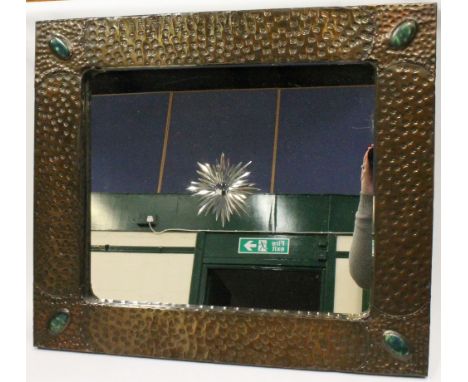 Arts & Crafts style wall mirror in rosette hammered brass frame with enamel oval inserts at the corners, the plate with etche