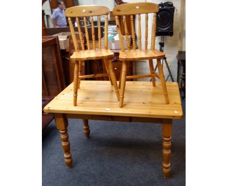 A modern pine kitchen dining table, and a pair of stick back dining chairs