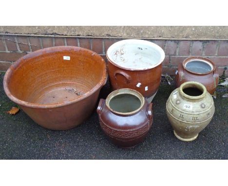A large terracotta planter, together with four other stoneware pots, one with Roman numeral collar