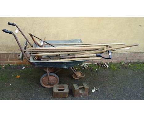 A galvanised three wheel barrow, together with a quantity of early 20th century hand tools and two 56LB weights