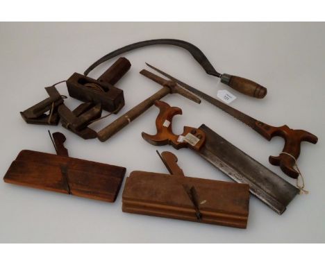 A small quantity of early 20th century hand tools, including a tenon saw, sickle, moulding planes, etc