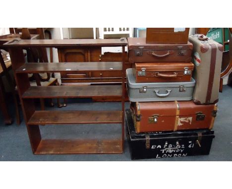 A pine five tier open bookcase, an Edwardian tin cabin trunk and various other luggage, some with destination labels