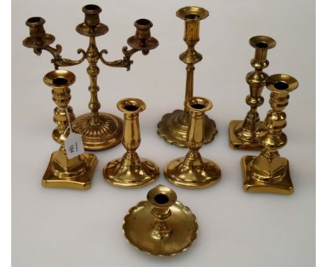 A pair of brass ejector candlesticks, a petal base candlestick and five other brass candlesticks