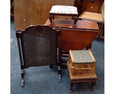 A small oak drop leaf gateleg dining table, a bobbin turned cane upholstered firescreen and three footstools