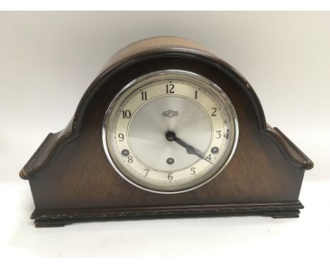 A mahogany cased Garrard mantle clock with silvered dial and Arabic numerals. Key and pendulum included.
