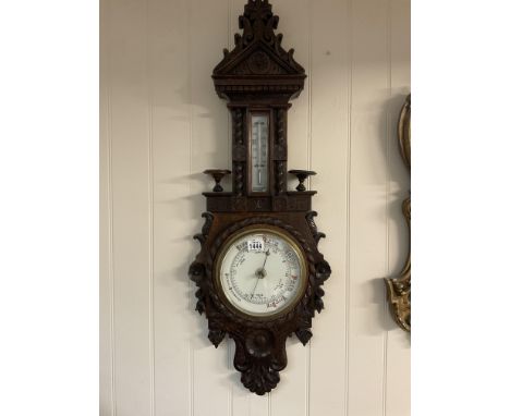 A Victorian carved oak barometer.