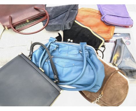 A mix of leather and suede handbags along with a gear stick cover