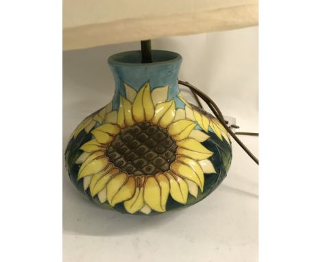 A Moorcroft table lamp decorated with sunflowers. 30 cm.