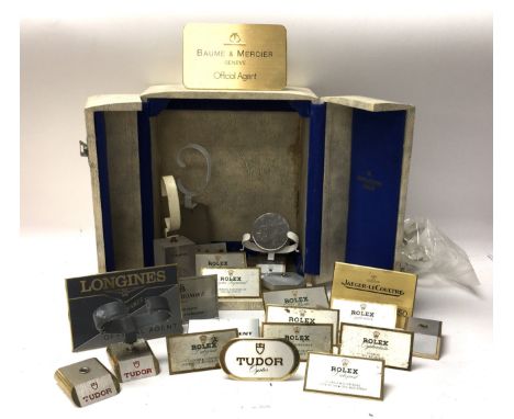 A collection of Prestige watch window display signs for Rolex, Longines, Chopard, Baume &amp; Mercier, Jaeger Le Coultre toge