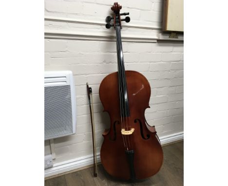 A cello, with bow and a canvas case. The model is Tatra by Rosetti Stradivarius.