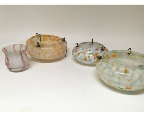 Four vintage coloured marbled effect glass light shades.