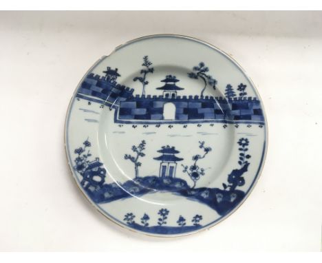 A blue and white plate depicting part of The Great Wall of China, approx diameter 22cm.