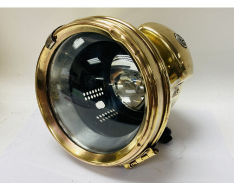 A Miller Brass head lamp possibly a Motorcycle Cycle ( possibly a motorcycle with side mounts).