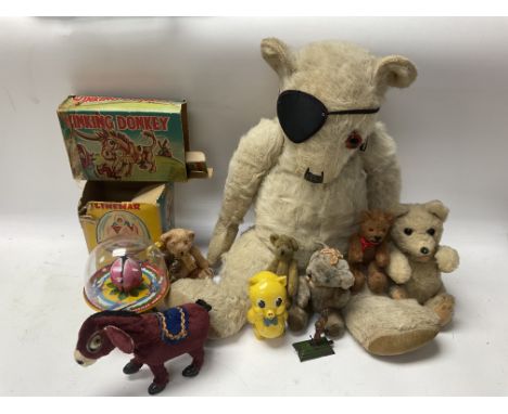 A mixed collection of vintage toys and bears to include a Boxed Walking clockwork donkey , Linemar tin plate magic top etc.