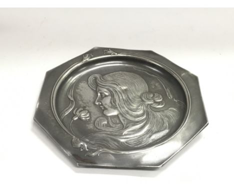 A WMF Art Nouveau pewter plate of octagonal form decorated with a girl in profile and stylised flowers, approx diameter 22cm.