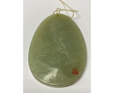 A small carved mutton fat jade pendant with an image of Buddha, signed with a red seal mark to lower right. 7 x 4.5cm.