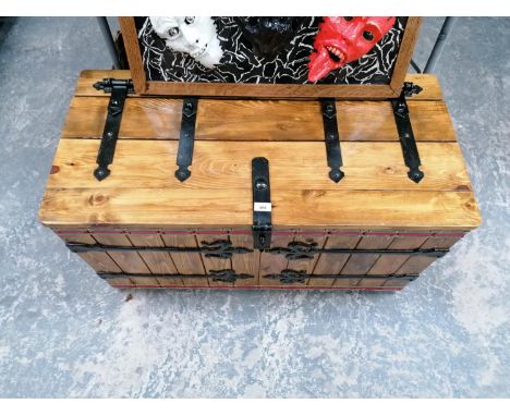 A LARGE SOIL WOOD AND IRON WORK STORAGE TRUNK 