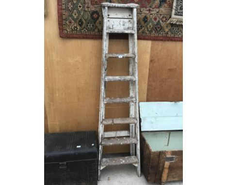 A PAIR OF VINTAGE SEVEN RUNG WOODEN STEP LADDERS 
