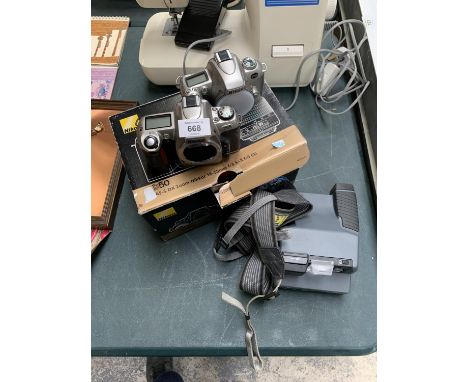 A VINTAGE STYLE POLAROID CAMERA TOGETHER WITH TWO NIKON CAMERAS 