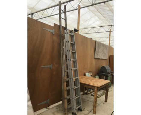 THREE ALUMINIUM LADDERS LADDERS TO INCLUDE AAN EIGHTEEN RUNG TWO SECTION, A SIX RUNG STEP LADDER AND A TWELVE RUNG LADDER 