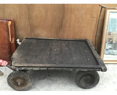A VINTAGE FOUR WHEELED RAILWAY LUGGAGE TROLLEY 