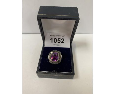 A RING WITH A PURPLE STONE DESIGN, BOXED 