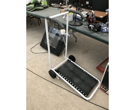 A FOLD OUT MANUAL TREAD MILL WITH EFFORT GAUGE 