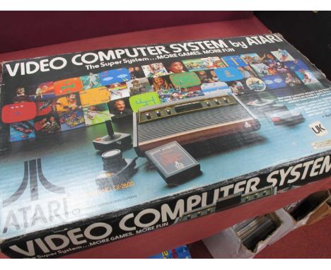 A boxed Atari CX-2600 Video Computer System, s/n 548395067, two controllers (one damaged), owners manual, box poor.