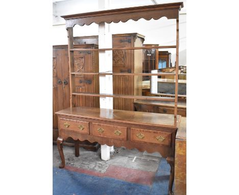 A 19th Century Crossbanded Oak Dresser Base with Pierced Brass Drop Handles to Three Drawers, Shaped Apron and Cabriole Suppo