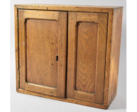 A Wall Hanging Oak Cabinet with Panelled Door, 35.5cm Wide 