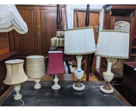 A selection of lamps to include a pair of white onyx and gilt metal lamps with fabric shades, three other onyx lamps, and a b