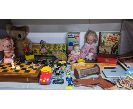 A selection of vintage toys, games and books to include a folding chessboard with plastic chess and draughts, mini children's