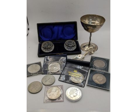 A white metal goblet, together with a cased pair of crystal cut and silver salts along with commemorative coinage to include 
