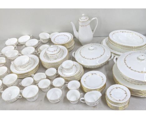 A Royal Worcester Gold Chantilly pattern dinner service to include cups and saucers, tureens, sugar bowl, serving plates and 