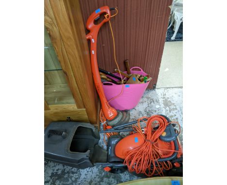 A Flymo Easimo electric lawnmower with grass basket, a Flymo Contour strimmer and a quantity of garden and woodworking tools 