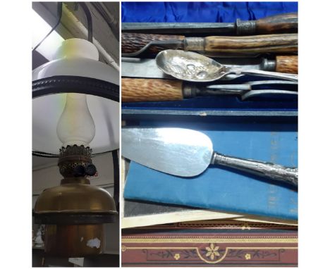 A ceiling gas light having a black wrought frame and a milk glass shade and mixed vintage items to include a horn handled car