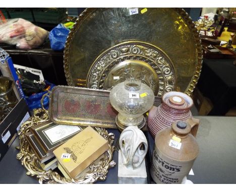 A good mixed lot to include large brass charger with engraved hieroglyphics, a brass oil lamp, stoneware bottle, mirror, ches